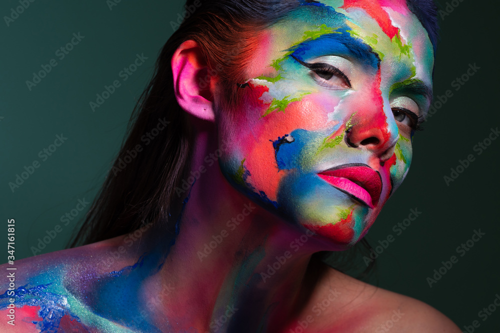 Face art and body art. Creative makeup with colorful patterns on the face. Modern makeup art, bold style, - obrazy, fototapety, plakaty 