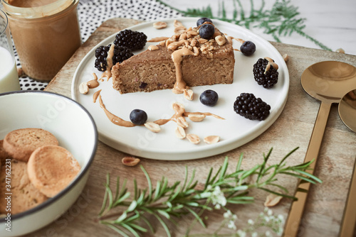 Piece of peanut butter cake, cookies and black berries 