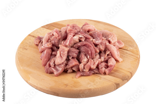 Chopped pork on a cutting board over a white background.