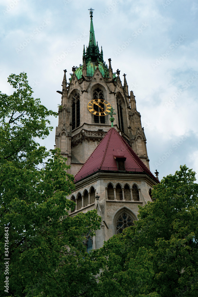 Bell tower of a church in Monaco of Bavaria. Check through the trees.