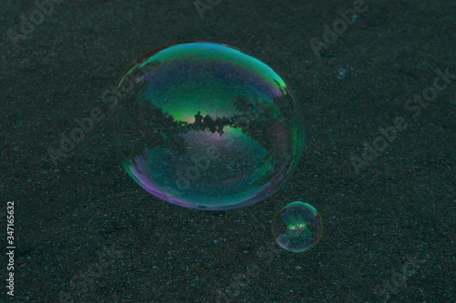 A soap bubble with reflection inside a small kiosk.