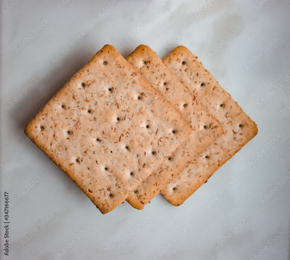 Flat lay. Top view. Lean ruddy crackers with bran lie on a white background Flat lay. Top view. Lean ruddy crackers with bran lie on a white background
