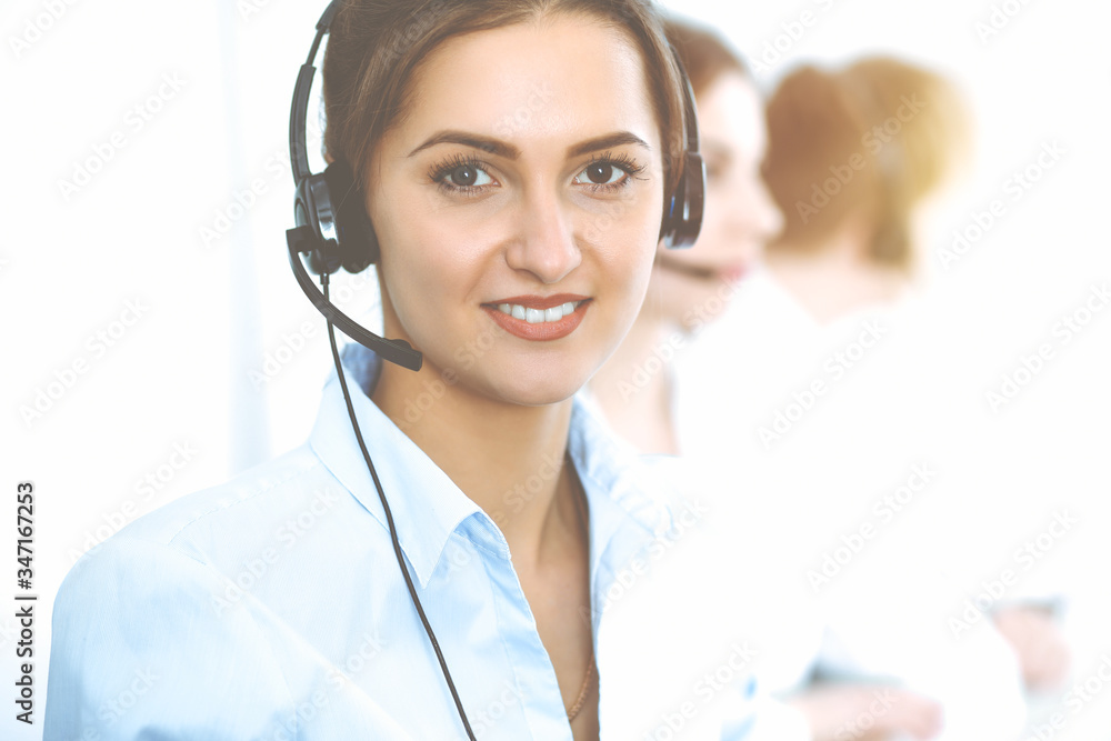 Call center. Focus on beautiful business woman in headset Call center. Focus on beautiful business woman in headset