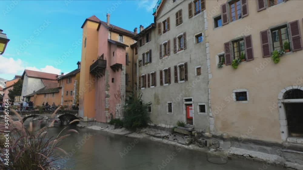 DOLLY SHOT Quai de l’Eveche street and bridge Pont Morens. Pont Morens is Annecy’s first stone bridge. It was covered by houses until the 19th century. DOLLY SHOT Quai de l’Eveche street and bridge Pont Morens. Pont Morens is Annecy’s first stone bridge. It was covered by houses until the 19th century.