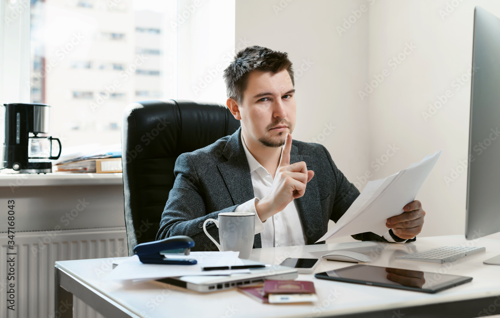 A middle-aged businessman analyzes a contract and prepares for a good deal or bargain The sales manager is preparing profitable offer for the customer. Office employee is sorting papers and documents A middle-aged businessman analyzes a contract and prepares for a good deal or bargain The sales manager is preparing profitable offer for the customer. Office employee is sorting papers and documents