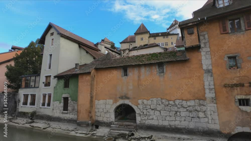 SLOW MOTION - The House of Charmoisy and the Ile palace (former prison) home to the Annecy History museum, Thiou canal and Île quayside and colorful houses, France. SLOW MOTION - The House of Charmoisy and the Ile palace (former prison) home to the Annecy History museum, Thiou canal and Île quayside and colorful houses, France.
