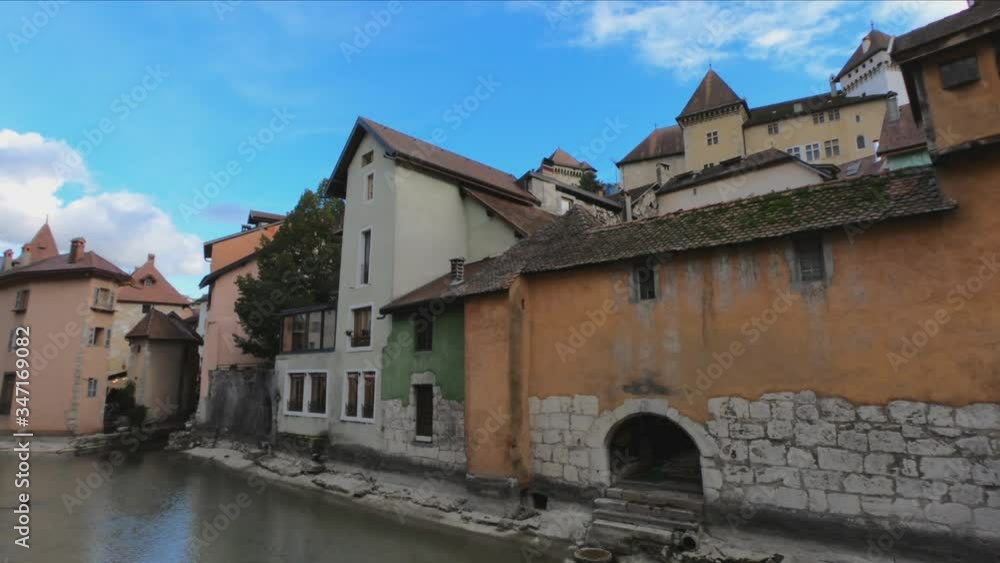 PAN SHOT - The House of Charmoisy and the Ile palace (former prison) home to the Annecy History museum, Thiou canal and Île quayside and colorful houses, France. PAN SHOT - The House of Charmoisy and the Ile palace (former prison) home to the Annecy History museum, Thiou canal and Île quayside and colorful houses, France.