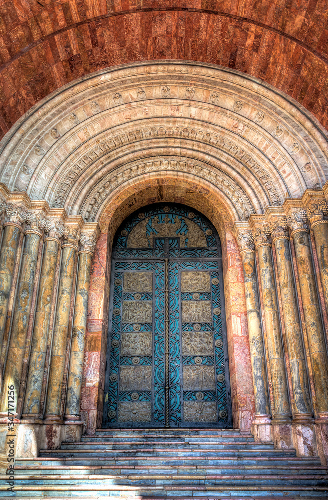 One of the many beautiful doors of Cuenca's Cathedral, made with stone and  marble and with stunning arches. Cuenca, Ecuador, South America.