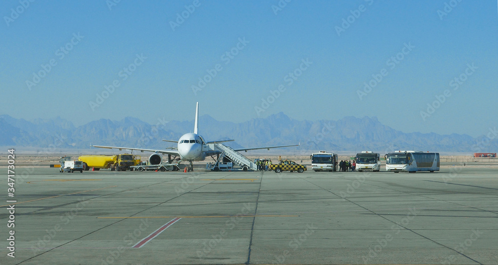 Fototapeta premium Airplane aircraft service at the mountain international airport