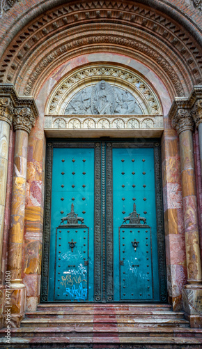 One of the many beautiful doors of Cuenca's Cathedral, made with stone and marble and with stunning arches. Cuenca, Ecuador, South America.