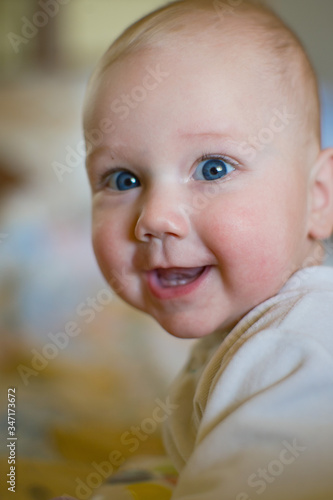 Caucasian toddler cute infant baby boy smiling with first teeth