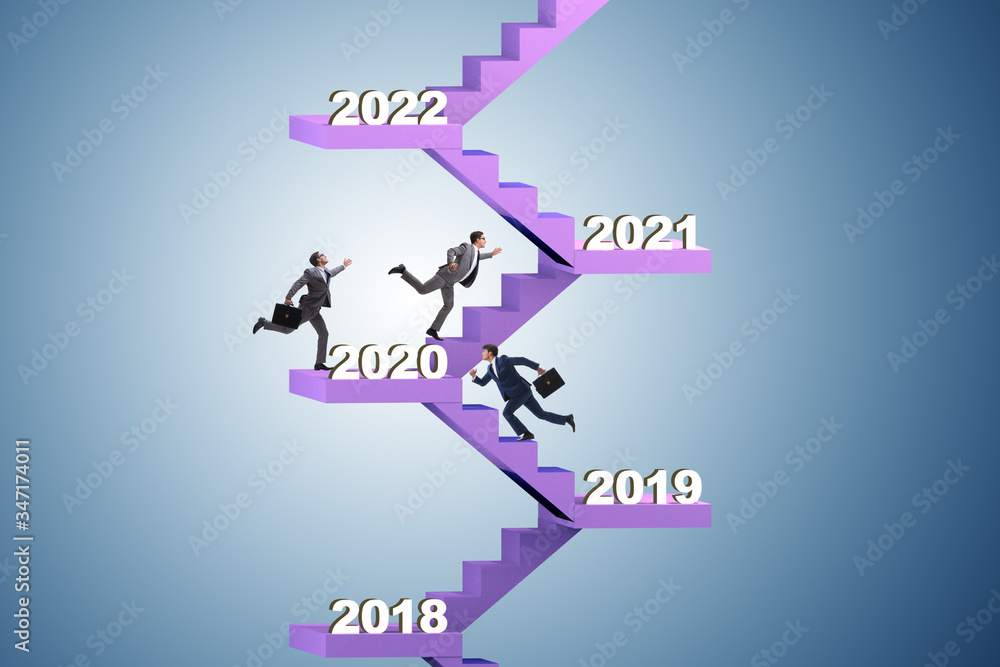 Businessman climbing stairs on yearly basis Businessman climbing stairs on yearly basis