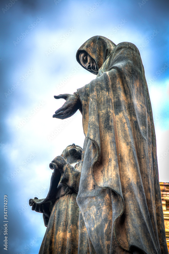 Statue of the Virgin Mary and a child, at the top of the Cuenca Cathedral, on a sunny and cloudy morning, Cuenca, Ecuador, South America.