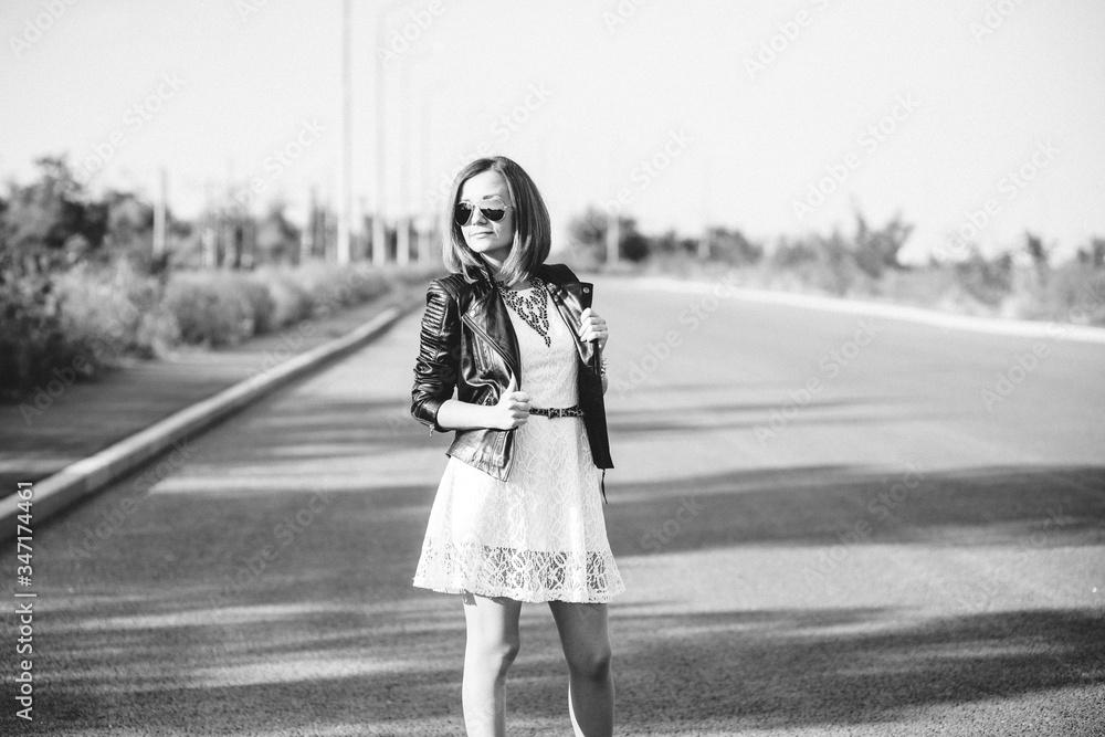 red-haired girl in a black jacket and blue glasses red-haired girl in a black jacket and blue glasses