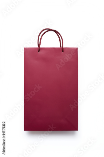 Red paper shopping bag isolated on white background