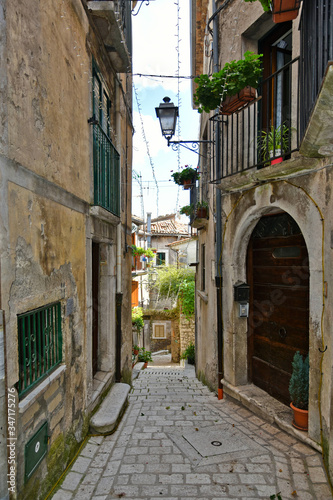 A narrow street between old buildings in the medieval town of Cusano Mutri  in the province of Avellino