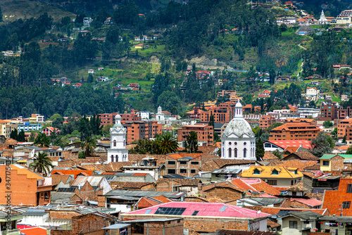 View of the city of Cuenca, with it's many churches, cathedrals and houses, in the middle of the Ecuadorian Andes, on a sunny afternoon, Ecuador, South America.