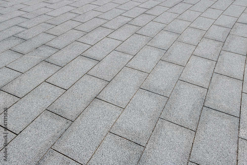 A pavement made of rectangular stone slabs.