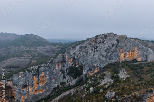 A picturesque landscape view of a cliff range in the valley of Rio Vero (Alquézar, Huesca, Spain) in the Spanish Pyrenees on a cold cloudy winter morning