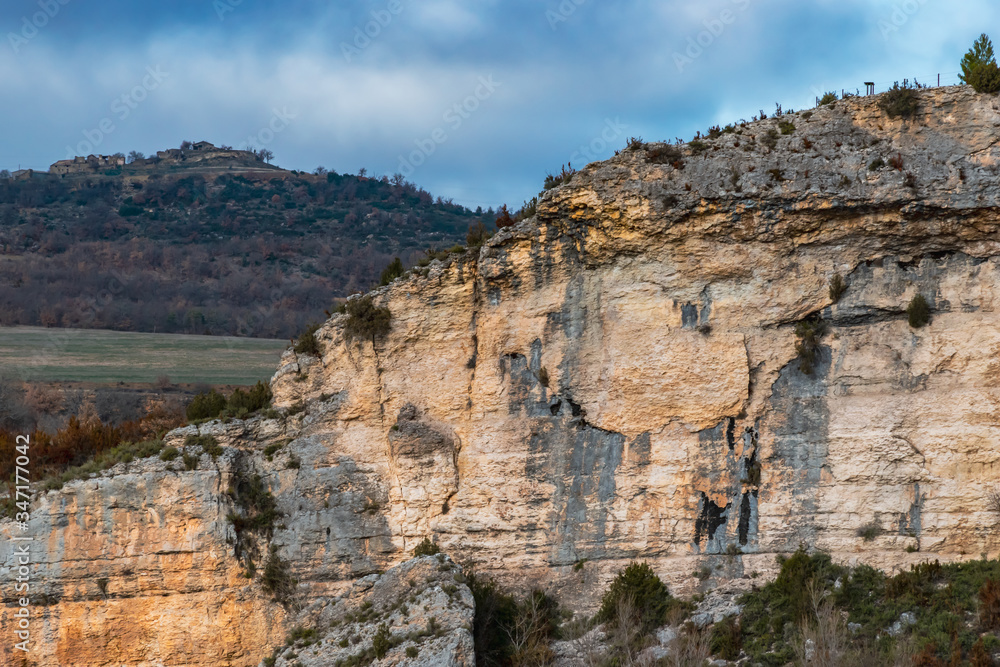A picturesque landscape view of a cliff range in the valley of the Canelles river in the natural park of Congost de Mont-rebei (Spain) A picturesque landscape view of a cliff range in the valley of the Canelles river in the natural park of Congost de Mont-rebei (Spain)