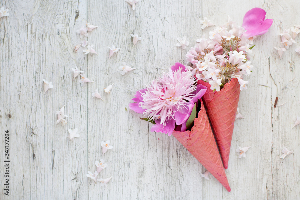 Bouquet - flower ice cream. Pink flowers in an ice cone