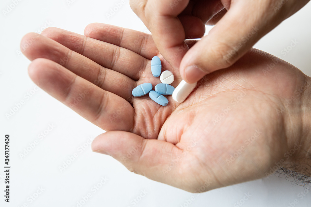 different pills in male hand isolate closeup
different pills in male hand isolate closeup