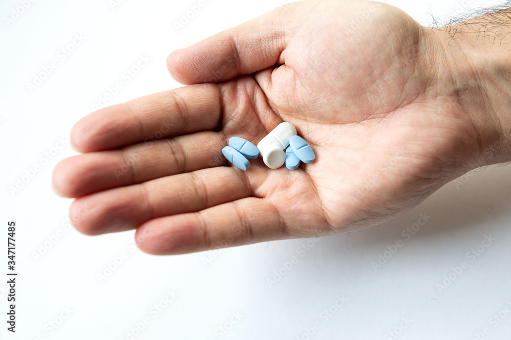 different pills in male hand isolate closeup
different pills in male hand isolate closeup