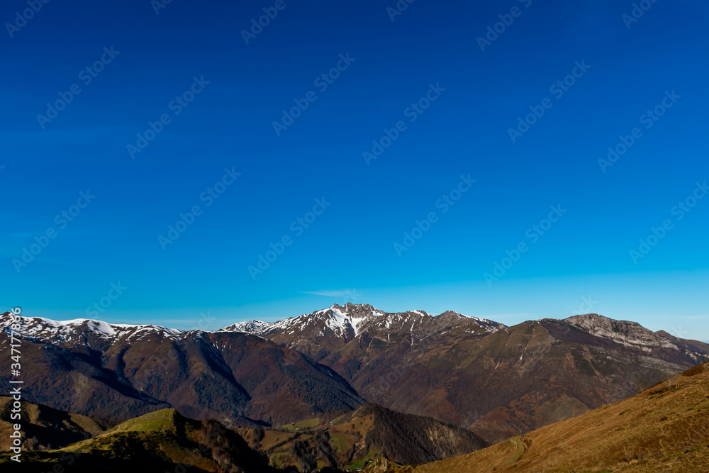 A picturesque landscape view of the snow capped French Pyrenees mountain range early in the morning in winter (Col de Soum)