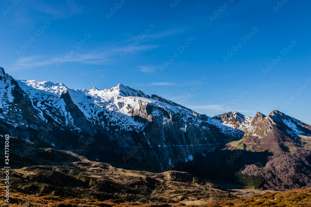 A picturesque landscape view of the snow capped French Pyrenees mountain range early in the morning in winter (Col de Soum)