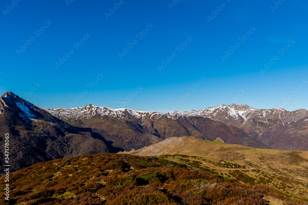 A picturesque landscape view of the snow capped French Pyrenees mountain range early in the morning in winter (Col de Soum)