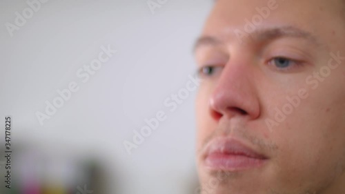 Young doctor takes off a medical mask. Protection against viruses and diseases