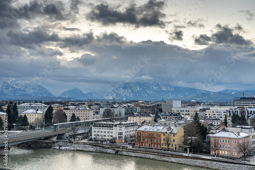 City of Salzburg south side view with snow mountain during winter at dusk blue hour © Davidzfr