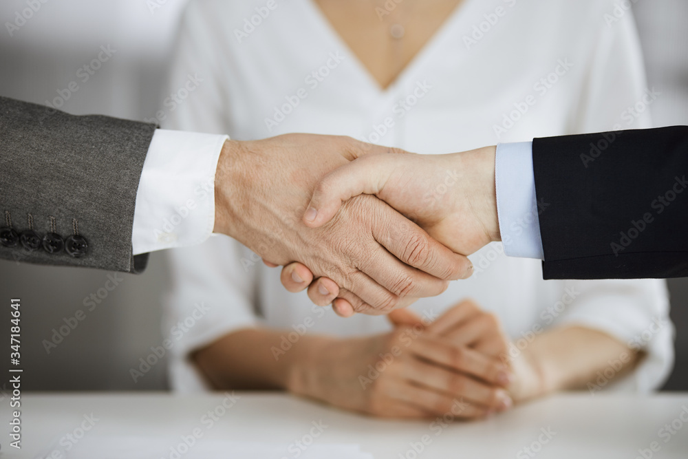 Business people shaking hands finishing contract signing, close-up. Business communication concept. Handshake and marketing