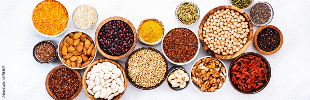 Various superfoods, legumes, cereals, nuts, seeds in bowls on white background. Superfood as chia, spirulina, beans, goji berries, quinoa, turmeric, mung bean, buckwheat, lentils, flax seed Various superfoods, legumes, cereals, nuts, seeds in bowls on white background. Superfood as chia, spirulina, beans, goji berries, quinoa, turmeric, mung bean, buckwheat, lentils, flax seed