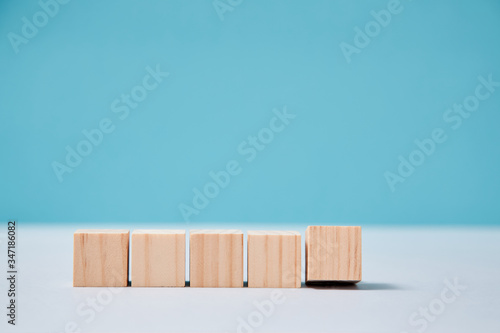Fototapeta Naklejka Na Ścianę i Meble -  Empty wooden cubes mockup for creative inscription design. Blank blocks in line template on blue background, copy space
