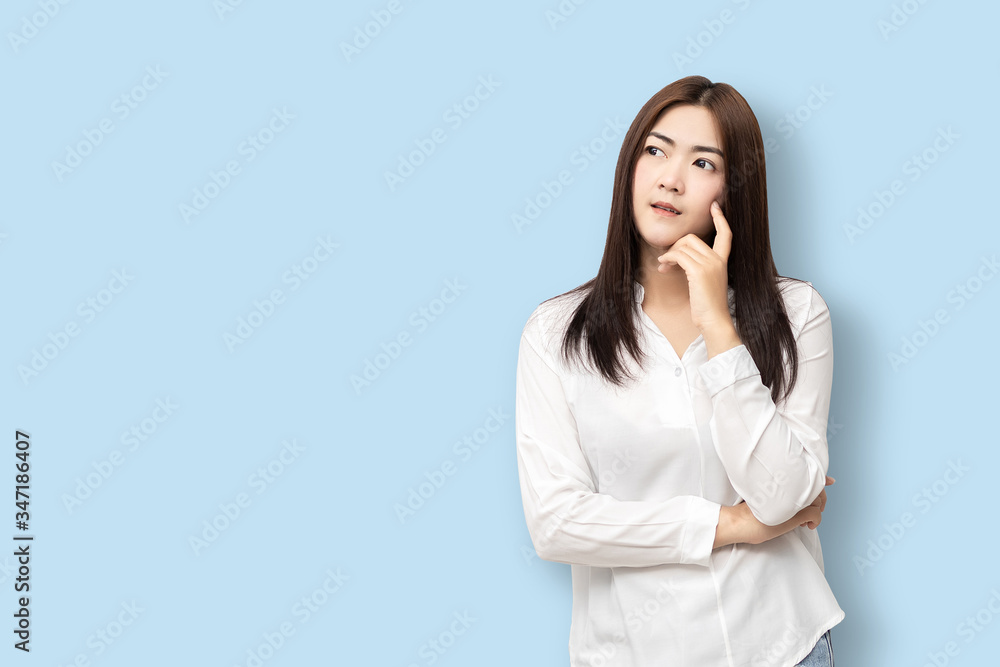 Long-haired Asian women are standing thinking. Long-haired Asian women are standing thinking.