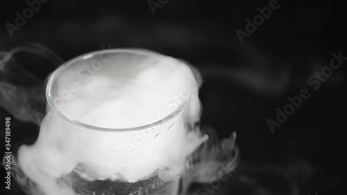 Smoke from drink in glass with the effect of dry ice.slow motion photo