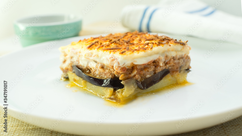 Original Mussaka from greece. Potatoes, aubergine, lamb meat, bechamel and cheese.