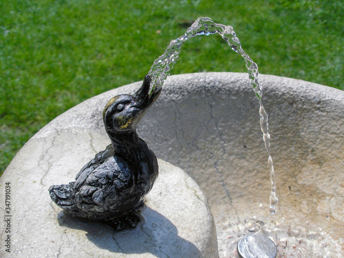 A duck-shaped fountain ejects water 