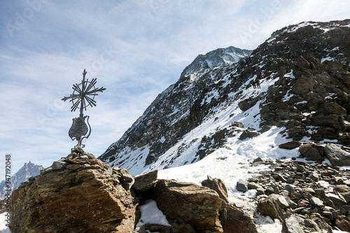 Haute-Savoie cross and stones near the Grand Couloir of Mont-blanc massif in the French Alps, Chamonix-Mont-Blanc, France. Scenic image of hiking concept