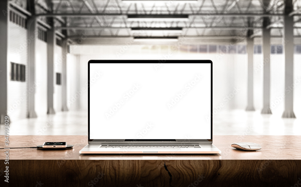 Laptop with blank screen on table in the production hall Laptop with blank screen on table in the production hall
