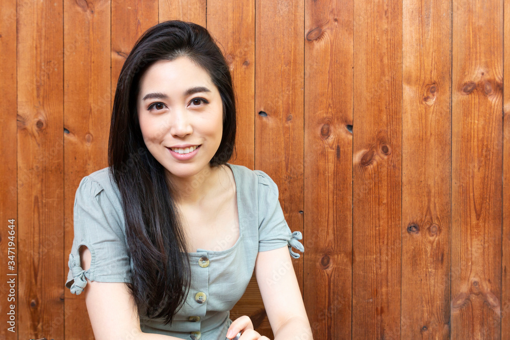 Portrait of young cheerful beautiful girl with dark long hair in casual outfit smiling. Beautiful young Asian girl posing and smiling happily travel. Portrait of young cheerful beautiful girl with dark long hair in casual outfit smiling. Beautiful young Asian girl posing and smiling happily travel.