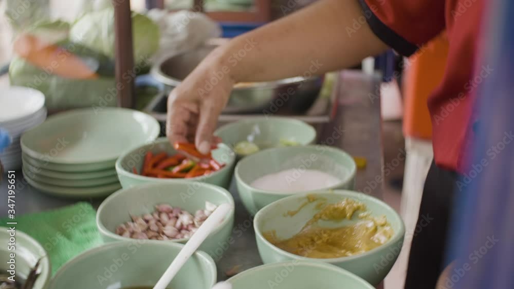 professional chef doing spicy papaya salad or Som Tum in Thailand Top view Thai food on table: Eating north eastern foods (SOM TUM - Spicy Papaya Salad, Sticky rice, NUM TOK - Spicy Soup). Local and t professional chef doing spicy papaya salad or Som Tum in Thailand Top view Thai food on table: Eating north eastern foods (SOM TUM - Spicy Papaya Salad, Sticky rice, NUM TOK - Spicy Soup). Local and t