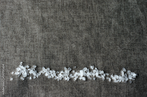 Coarse sea salt on a dark background    photo