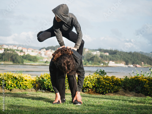 two children playing leapfrog in the garden