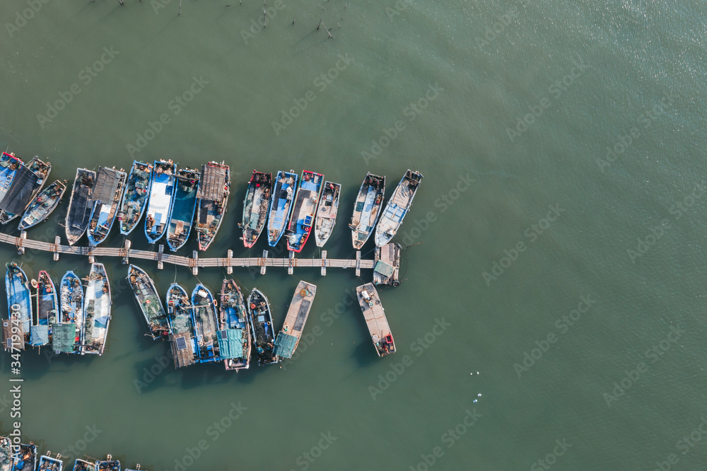 Aerial view of the fishing port with small wooden fishing boats in a traditional Chinese village in Xiamen