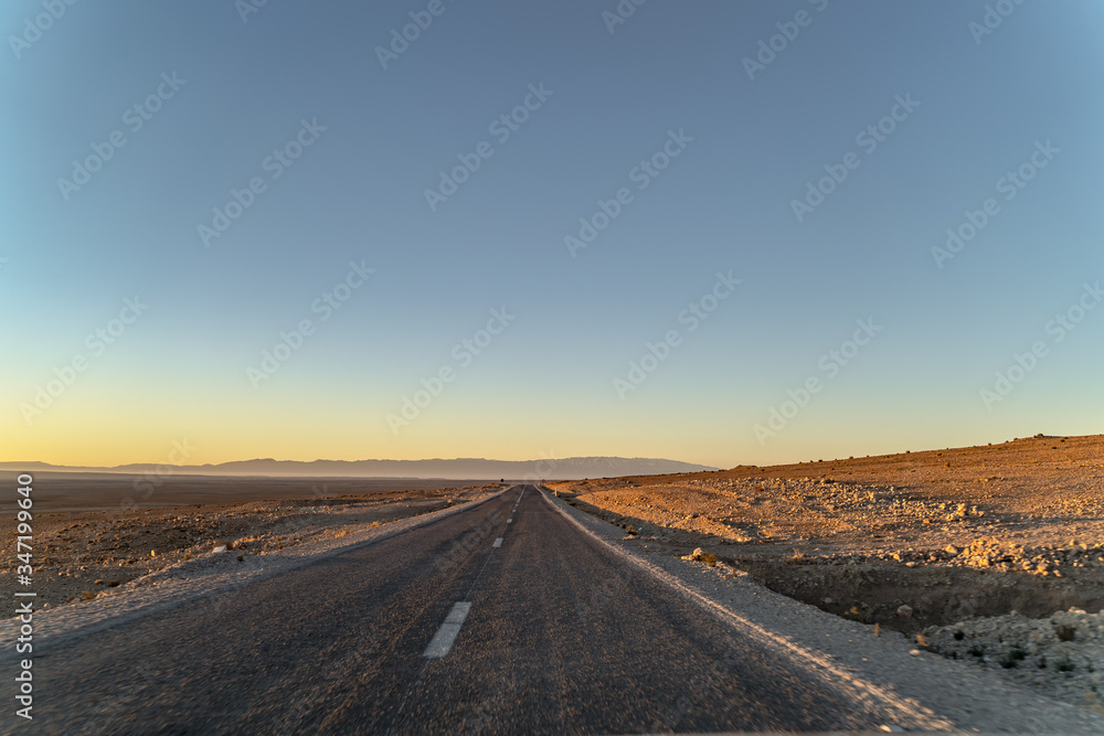 road at dawn in the Sahara desert in North Africa road at dawn in the Sahara desert in North Africa