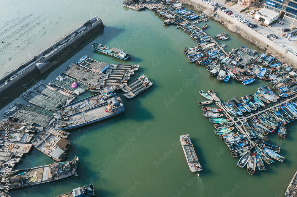 Aerial view of the fishing port with small wooden fishing boats in a traditional Chinese village in Xiamen