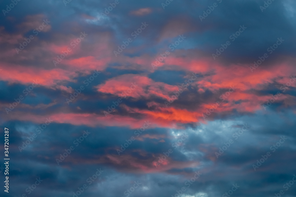 Amazing pink clouds in a dramatic sky at sunset - background