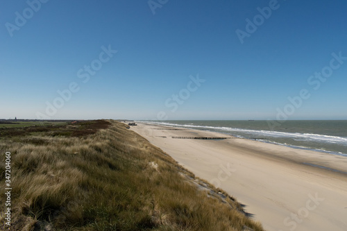 Sand dunes near to the sea with blue sky